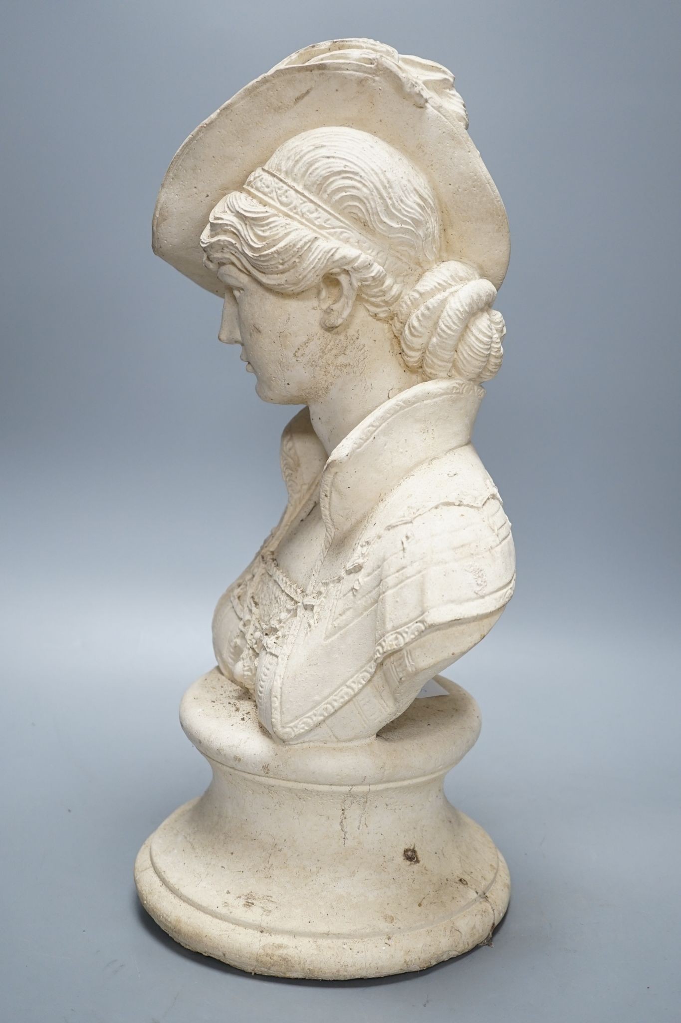 A composition bust of a 19th century lady in feather hat, 47 cms high.